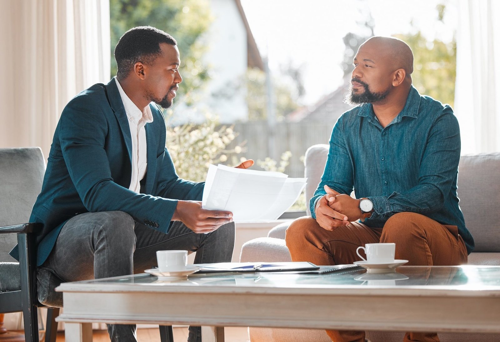 how-much-longer-will-this-meeting-be-shot-mature-man-having-meeting-with-finance-broker (1)-min