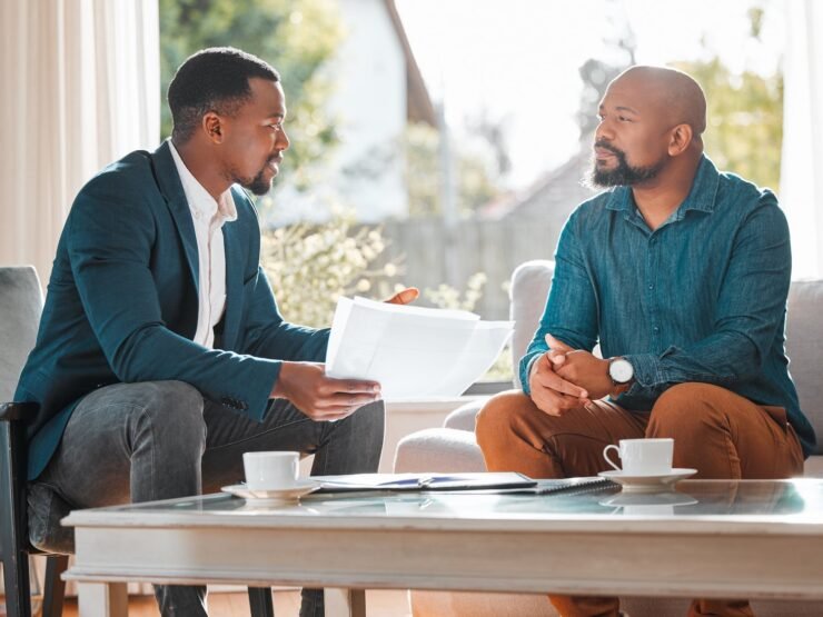 how-much-longer-will-this-meeting-be-shot-mature-man-having-meeting-with-finance-broker (1)-min